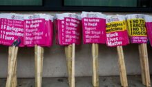 Placards wait ahead of an anti-racism march in London, in which speakers expressed anger at the Illegal Migration Bill.