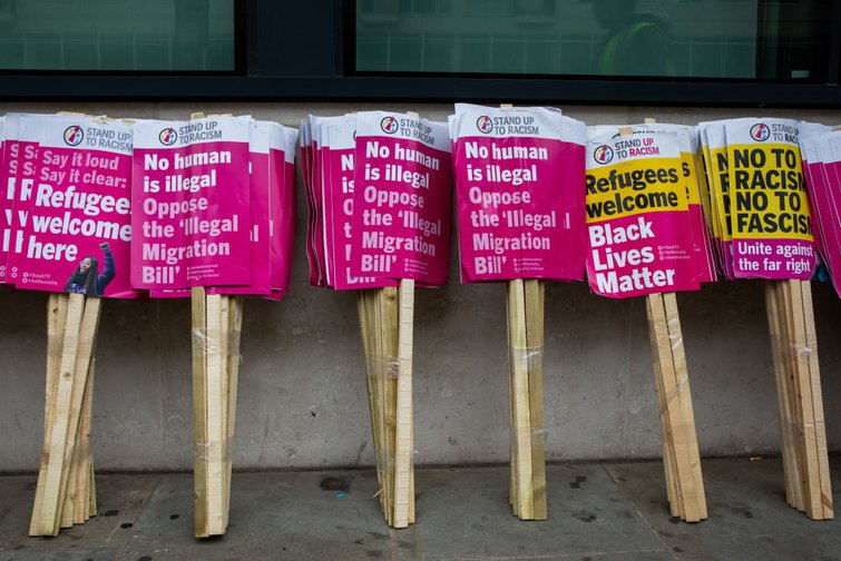 Placards wait ahead of an anti-racism march in London, in which speakers expressed anger at the Illegal Migration Bill.